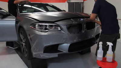 5 series in gray getting front bumper wrapped in ppf