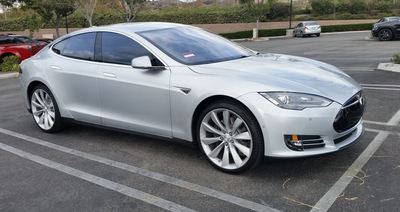 Silver Tesla in parking lot