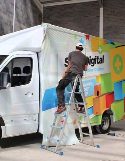 Man wrapping a commercial vehicle